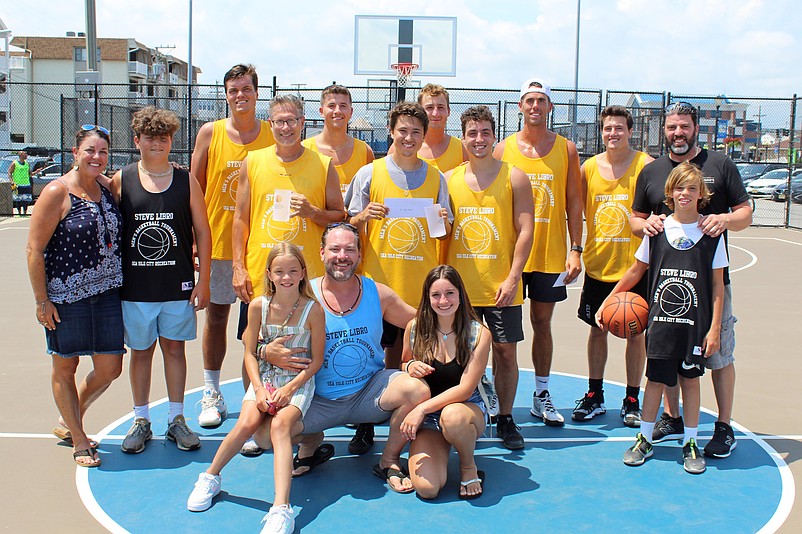 Members of the Libro family join with the winning team, GPA Boosters, in yellow jerseys, for a celebratory photo. (Courtesy of Sea Isle City)