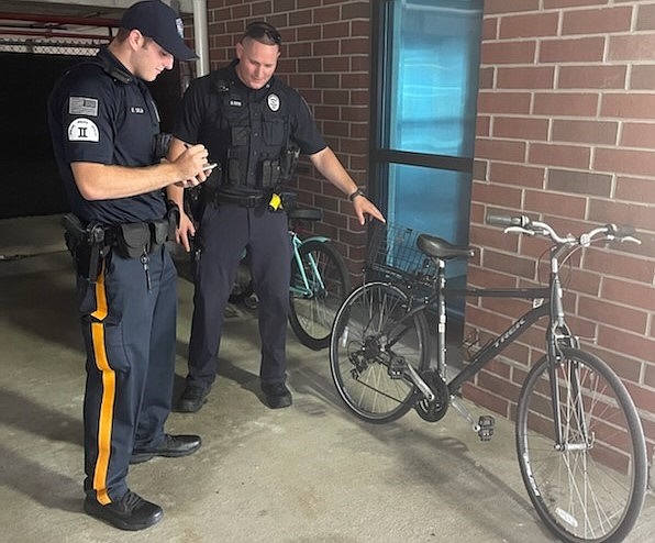 Patrolman Brandon Piper, right, and Class II Officer Ethan Selb bring four abandoned bikes in on Friday to put into evidence. (Photo courtesy of Sea Isle City Police Department) 