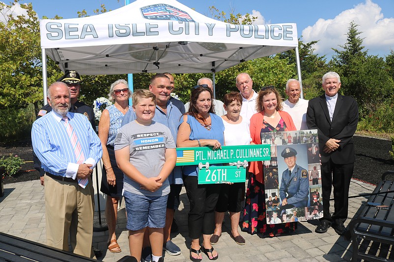 Family members are joined by city officials and others for a group photo after the ceremony.