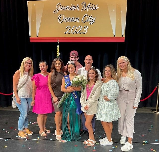 Newly crowned Junior Miss Ocean City Antonella DiAntonio with sister, Arianna, at right, parents, Angelina, pink dress, and Anthony, white shirt, and other family members celebrate backstage of the Music Pier Saturday night. (Photo courtesy of the DiAntonio family)