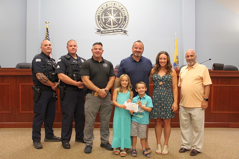 Shown with Cosette and Ryder Symons, from left, Patrolman Henry Frank, Sergeant Thomas Ready, Capt. Anthony Garreffi, Jason and Krista Symons, and Mayor Leonard Desiderio in 2022. (Photo courtesy of Sea Isle City)