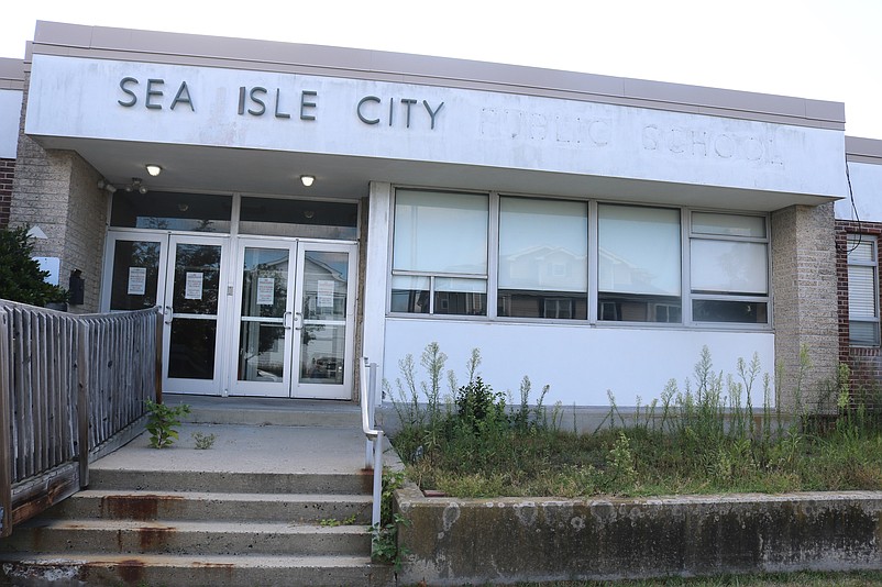 The words "Public School" have been removed from the now-empty building's front entrance.