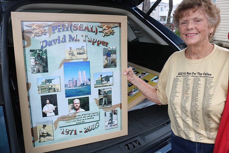 Judi Tapper, of Atco, N.J., displays a photo collage of her son, David Tapper. 