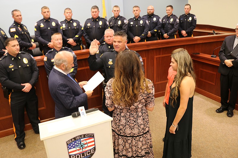 Garreffi takes the oath of office from Desiderio while surrounded by his wife, Stephanie, daughter, Madisyn, and son, Cole.