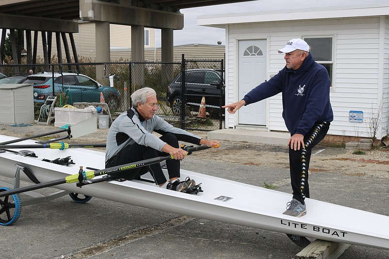 South Jersey Coastal Rowing Club board member Tom Feaster explains rowing techniques as Frank Glasior demonstrates.