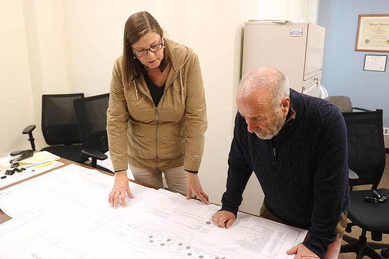 Sea Isle City's Public Information Officer Katherine Custer and Mayor Leonard Desiderio look at the latest plans for a dog park.