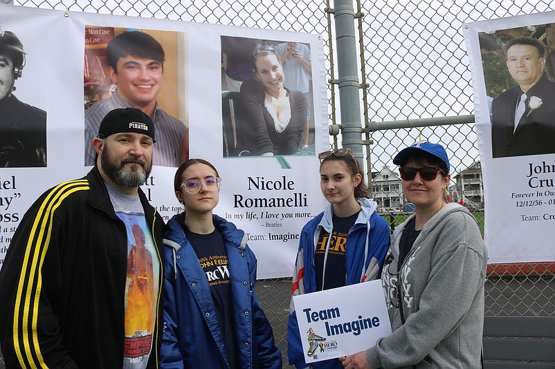 Bart and Michele Kohan, of Manchester Township in Ocean County, and their daughters, Payton, left, and Valerie, stand next to the memory banner for their relative Nicole Romanelli, killed by a drunken driver.