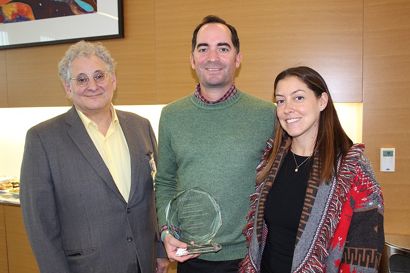 Dr. Leonard Galler, left, presents Chris and Andrea Monihan, of Ocean City, with the award. (Photo courtesy of Shore Medical Center)