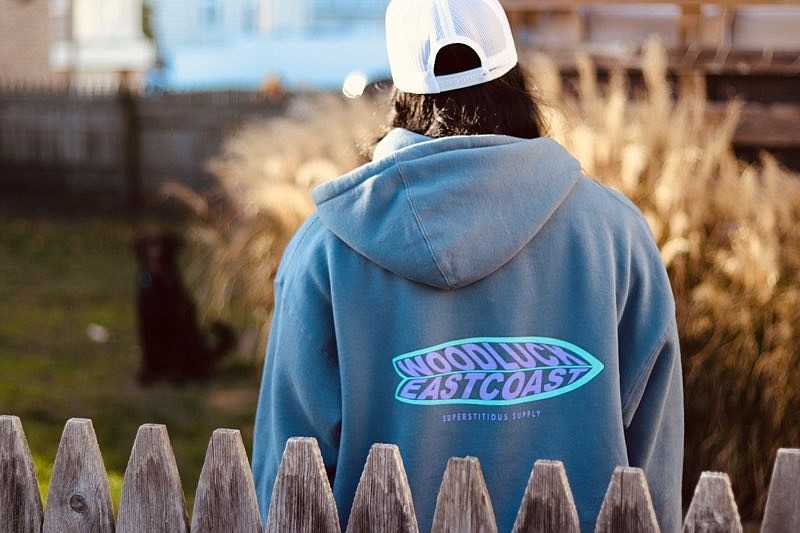 Some WoodLuck hoodies have surfboards on the back with the WoodLuck logo.