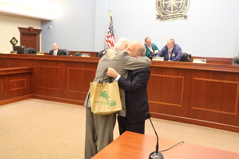 Cape May County Commission Director Gerald M. Thornton, left, and Sea Isle Mayor Leonard Desiderio exchange a hug.