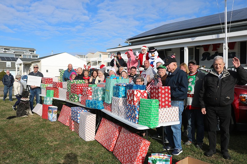 Members of VFW Post 1963 and its Auxiliary pose for a group photo with all of the gifts.