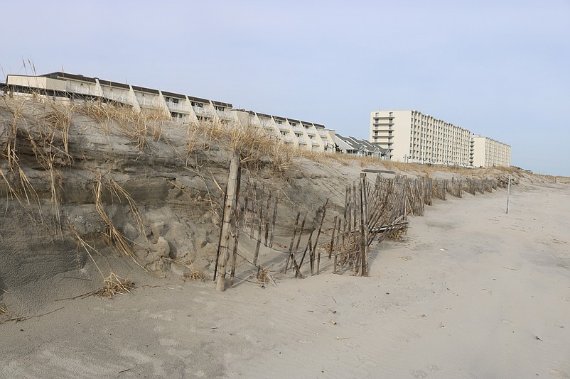 The wooden dune fencing near 40th Street is ripped to shreds by the waves.