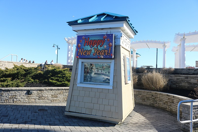 An electronic sign at the foot of the Promenade welcomes visitors with the words "Happy New Year."