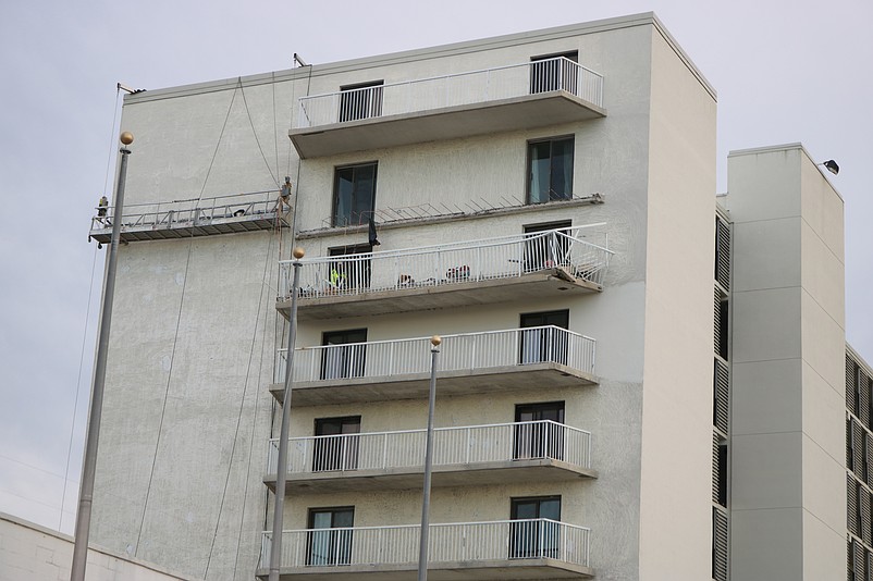 The Spinnaker condominium balcony on the eighth floor collapses onto the one below, trapping the worker.