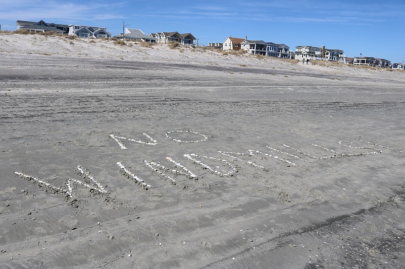 The words "No Windmills" are inscribed in the beach sand close to where the dolphins became stranded.