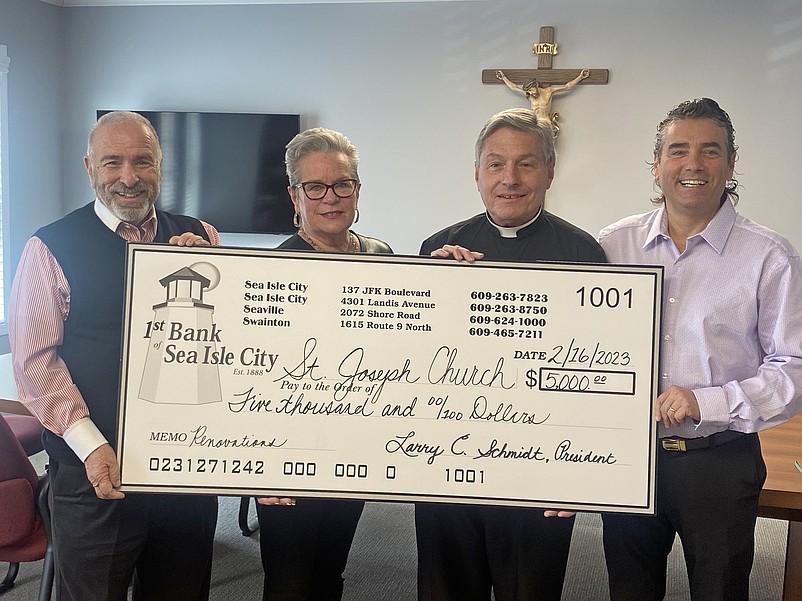 From left, First Bank Chairman and Sea Isle Mayor Leonard Desiderio, First Bank Chief Financial Officer Angela Kelly, St. Joseph Catholic Church Pastor Perry Cherubini and First Bank Vice-Chairman Joe Romano hold a ceremonial check for the donation. (Photo courtesy of Sea Isle City)