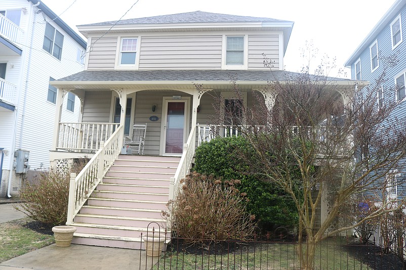 The wooden steps lead to a wraparound porch.