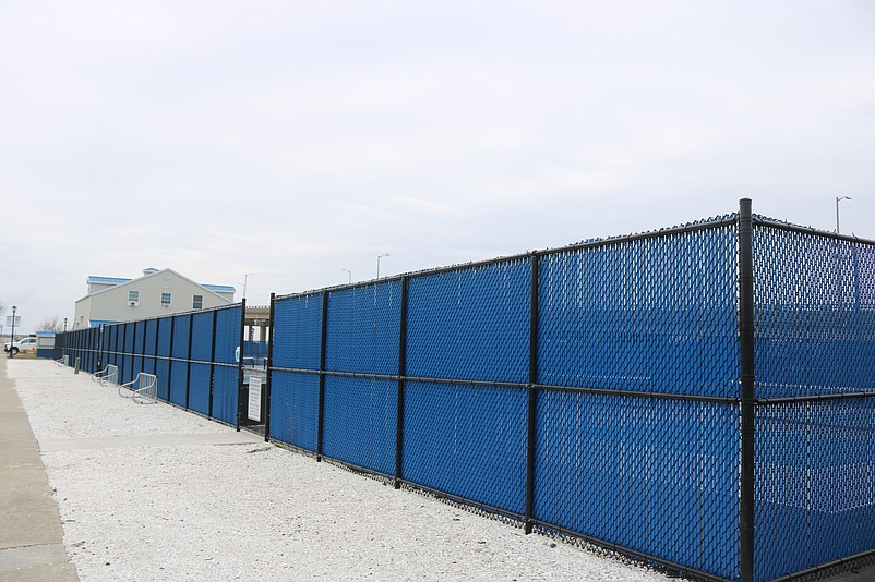 Colored blue, the vinyl strips are woven into the chain-link fence that surrounds the pickleball courts to create a wind barrier.