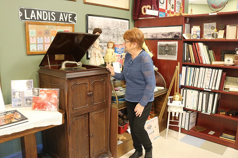 Joyce Molter, the museum's new president, looks at a vintage record player that is one of the artifacts on display.