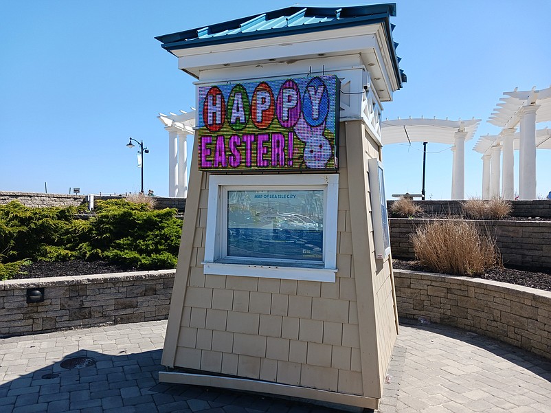 A digital sign next to the Promenade greets visitors with the words "Happy Easter!"