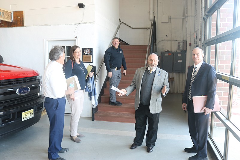 Mayor Leonard Desiderio, center, discusses the importance of having overnight fire crews during a tour of the fire station with other city officials.