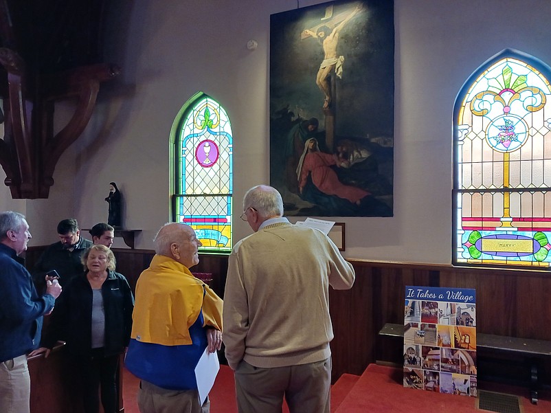 Church members admire the restored painting called "Christ on the Cross."