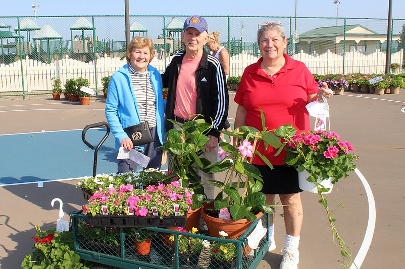 Garden Club event organizer Donna Hadfield (far right) assists customers at the 2022 flower show. (Photo courtesy of Sea Isle City)