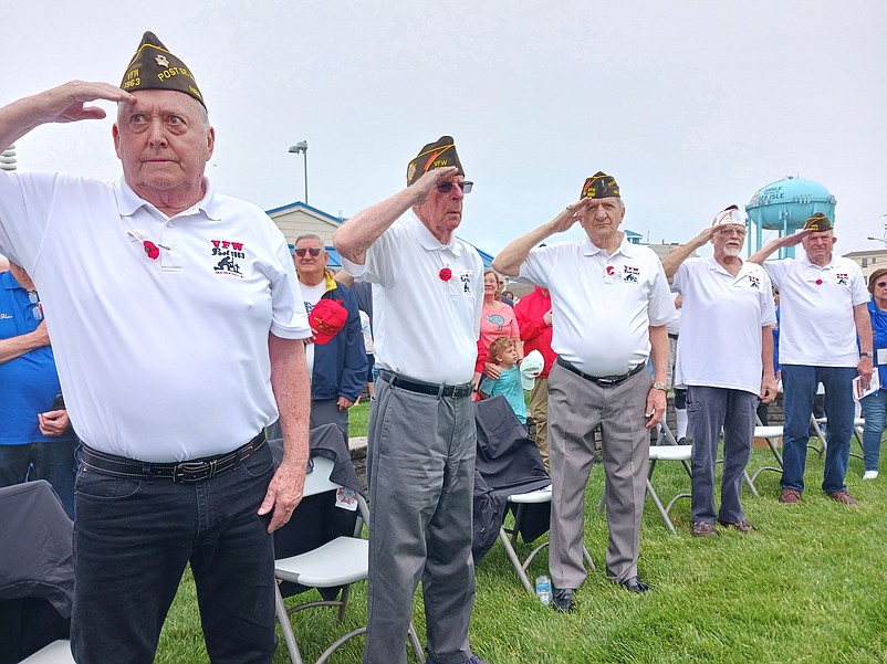 From left to right, veterans Harry Strack, Frank Diamond, Vince Conte, Charles "Chick" Haines and Jim Gibbons salute during the playing of the national anthem.