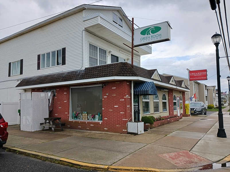 The existing building now serves as commercial space for a catering business and a real estate firm.