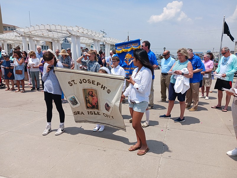 Marchers hold a banner for the church.