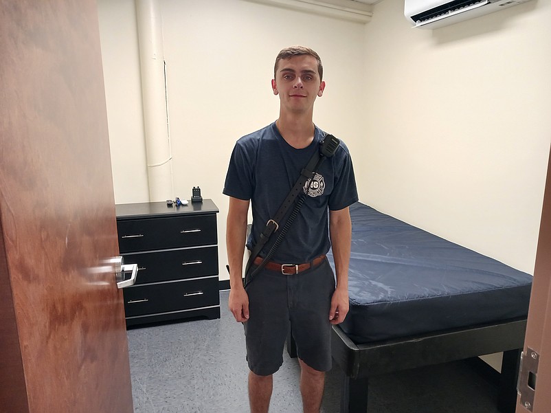 Volunteer firefighter Robbie Lane stands inside one of the new bunk rooms at the fire station.