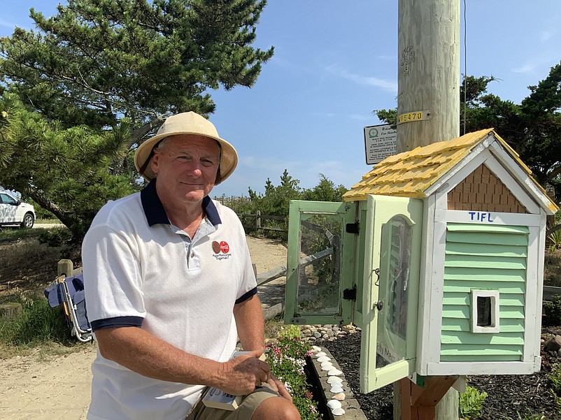 Tim Kelly stands beside one of the mini-libraries created in Townsends Inlet. (Photos by Kelly McCarthy)