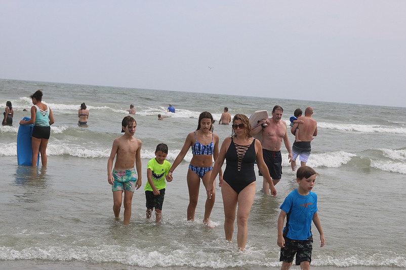 Ocean City beachgoers splash in the surf.