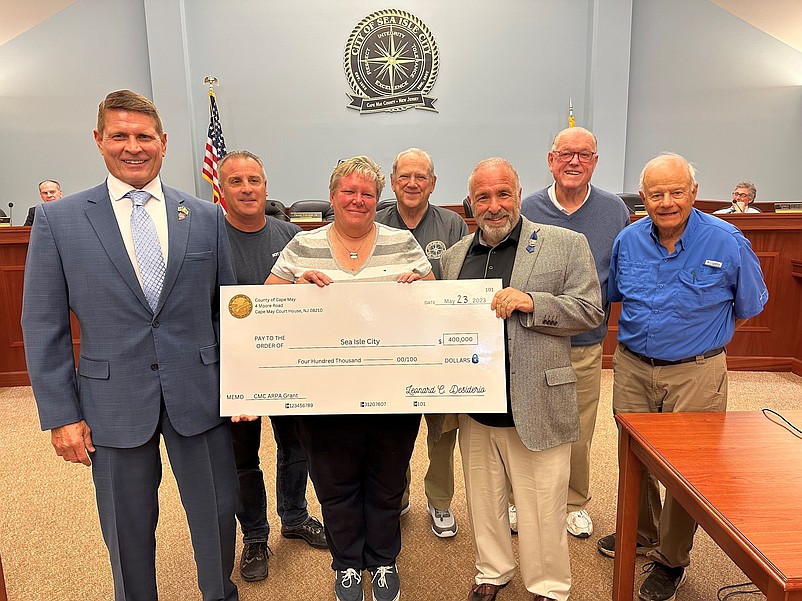 Cape May County Commissioner Andrew Bulakowski, left, joins with Sea Isle officials for   a check-presentation ceremony. (Courtesy of Sea Isle City)