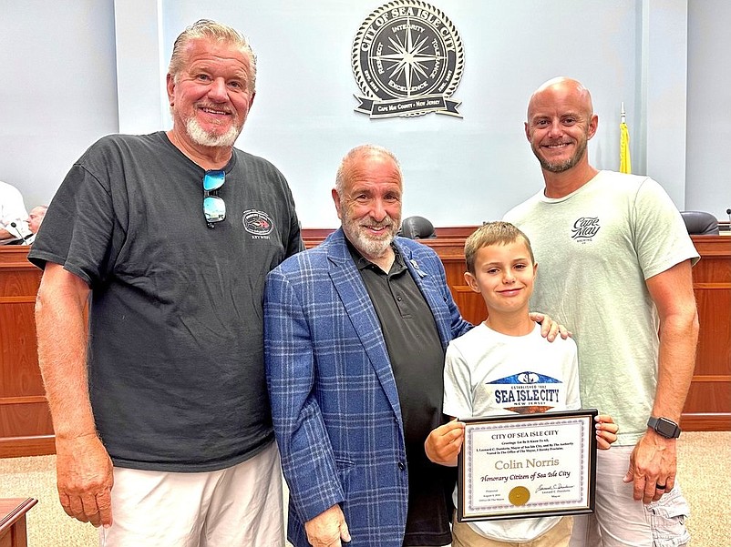 Colin and Mayor Leonard Desiderio are joined by Colin's grandfather, Kevin Norris Sr., and father, Kevin Norris Jr., for the ceremony. (Photo courtesy of Sea Isle City)