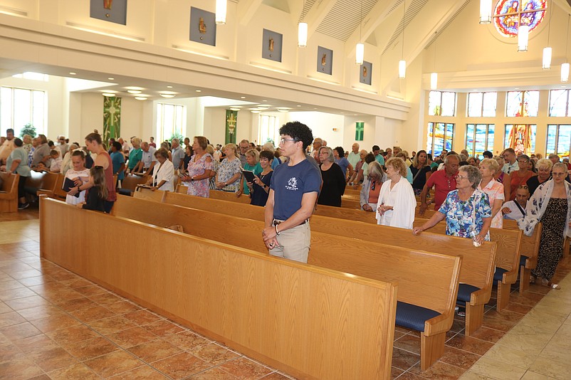 Parishioners fill the church sanctuary for a special Mass preceding the procession.