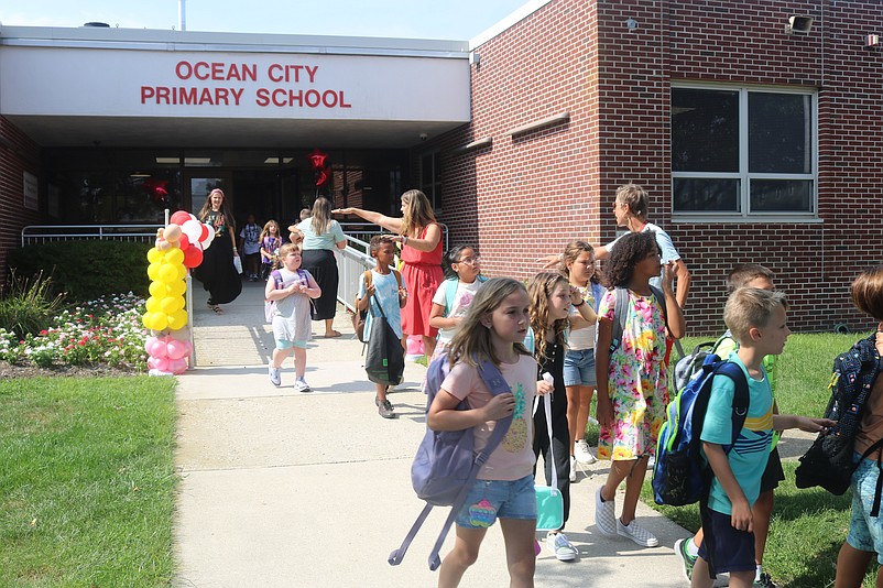 Primary School faculty direct students during dismissal.