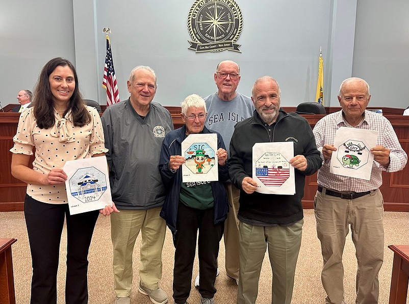 Mayor Leonard Desiderio, second from right, and other Sea Isle City officials show the winning designs for the 2024 Beach Tag Art Contest. (Photo courtesy of Sea Isle City)