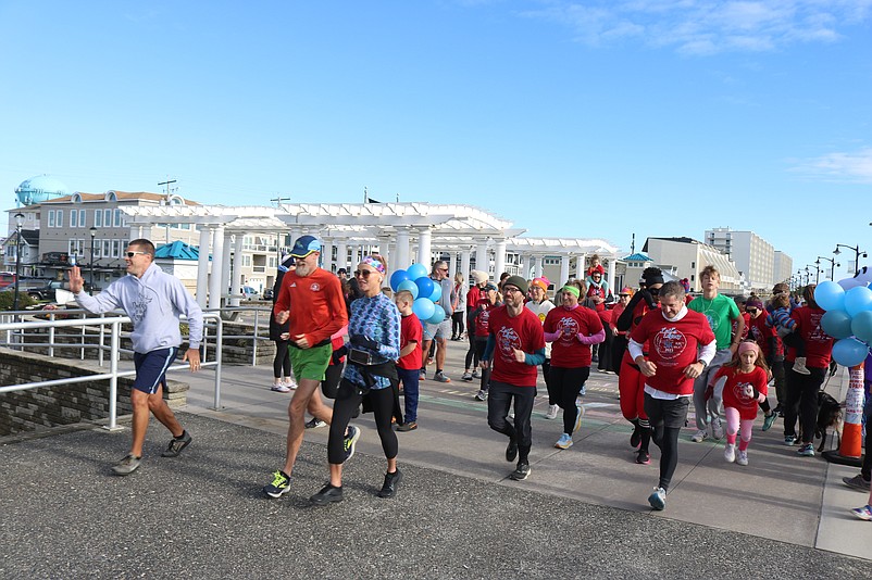 Runners take off at the starting line.