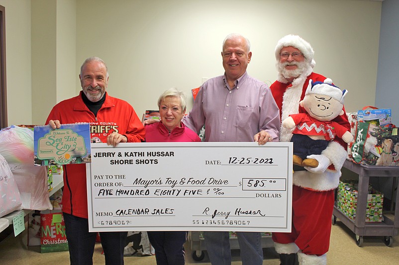 Photographer Jerry Hussar (second from right) is shown with Mayor Leonard Desiderio, Mayor’s Assistant Pattiann Ponichtera and Santa Claus while donating money to the mayor’s 2022 Holiday Toy and Food Drive. (Photo courtesy of Sea Isle City)