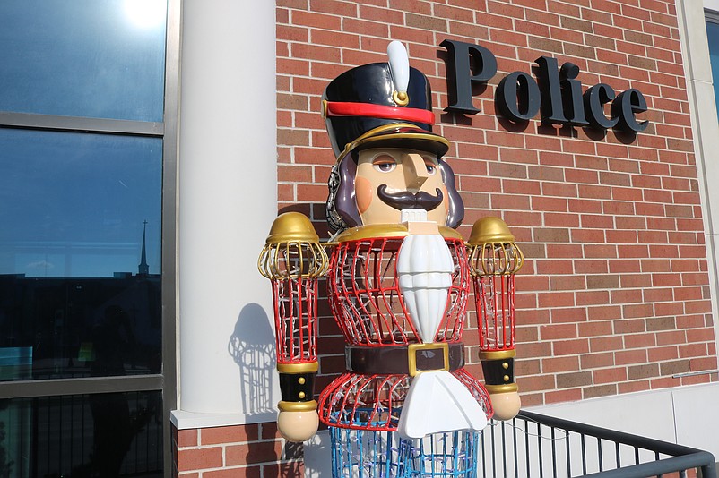 A toy soldier stands guard at the entrance of City Hall.