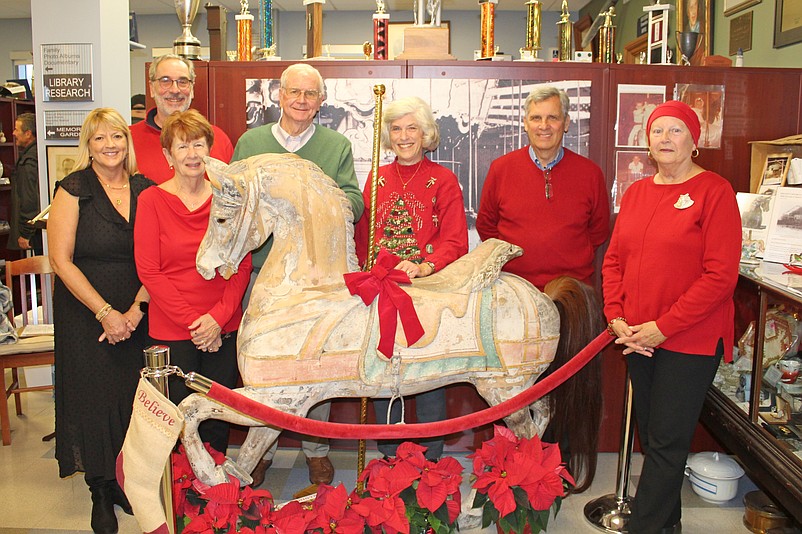 Historical Society members (from left) Abby Powell, Gary Kriss, Joyce Molter, Mike McHale, Lynne Shirk, Ron Kovatis and Barbara McKeefery are shown during 2022’s Open House, during which a vintage carousel horse was unveiled. (Photo courtesy of Sea Isle City)