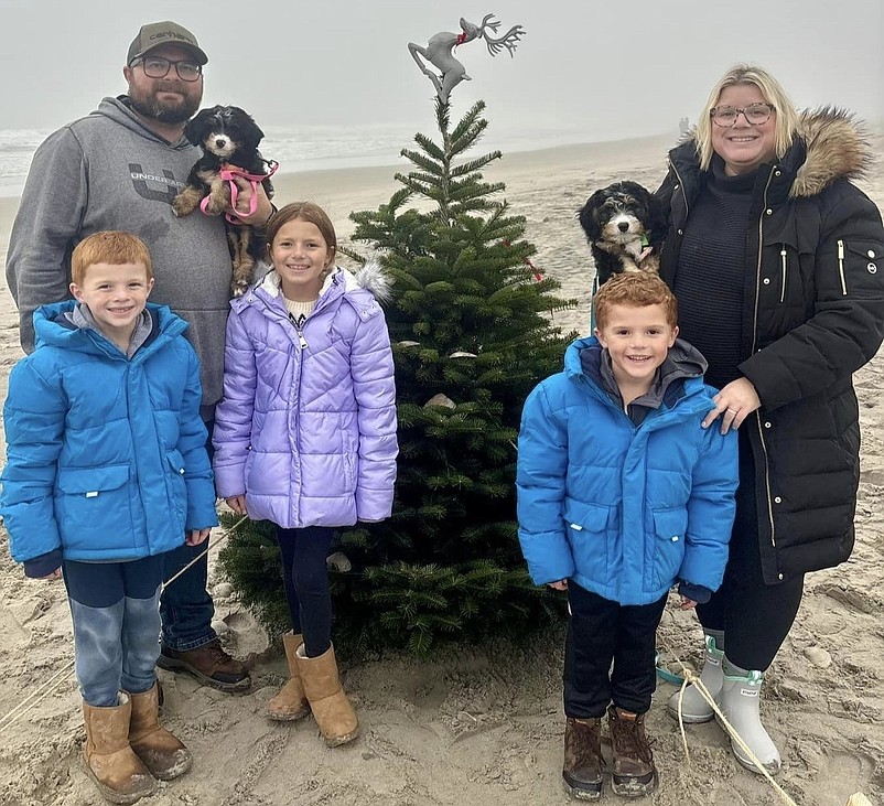 Nick and Shannon Giordano pose for a family photo next to the tree with their children, Giovanni, Gracelynn and Vincenzo, and their dogs, Willow and Beau. (Photo courtesy of Shannon Giordano)