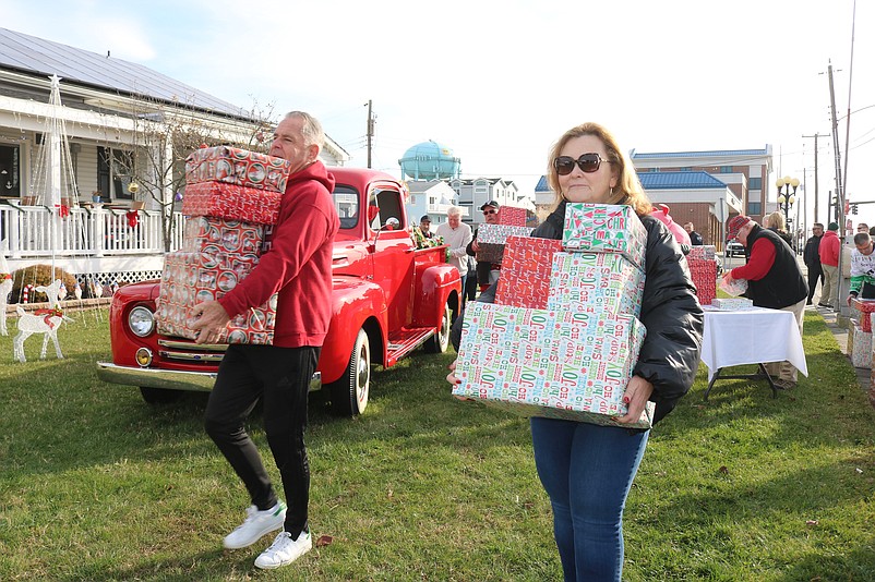 Pastor Melissa Doyle-Waid of the United Methodist Church in Sea Isle helps to load the Christmas gifts.