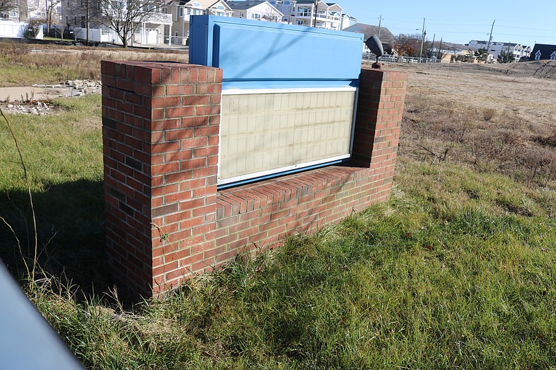 The old school has been demolished, but its sign still remains at the site.