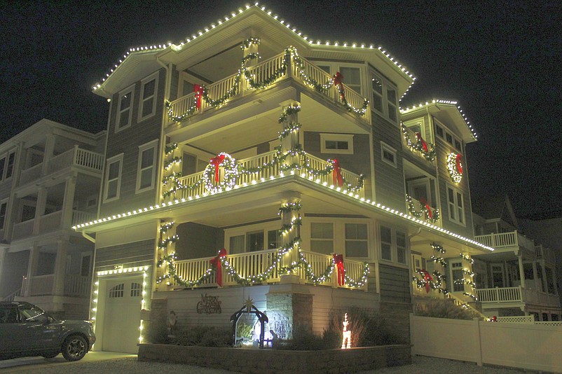 A Sea Isle City home is decorated in white lights, garland and red bows in 2022. (Photo courtesy of Sea Isle City)