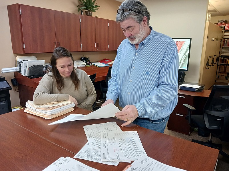 Sea Isle Construction Official Neil Byrne and technical assistant Mariah Rodia look over the 2023 housing market statistics.