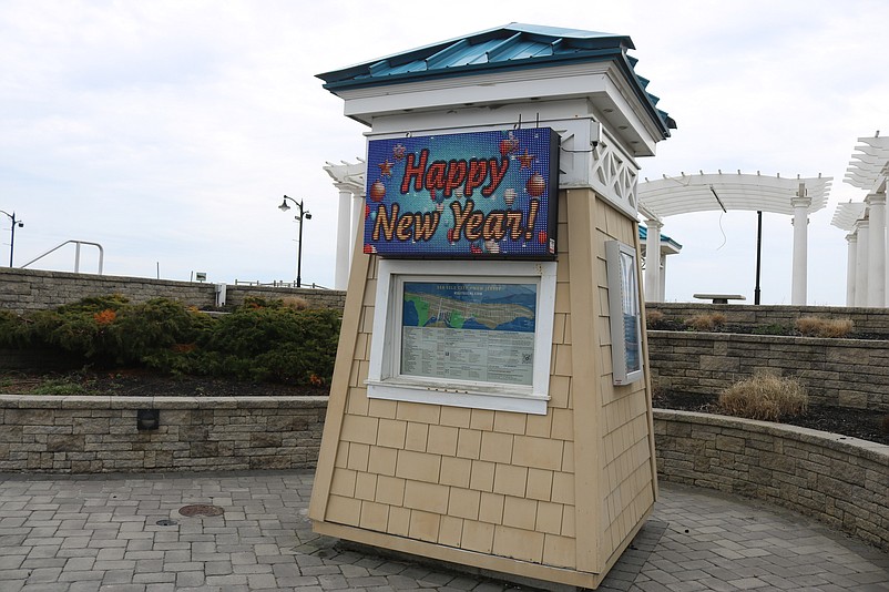 A digital sign next to the Promenade flashes "Happy New Year!"