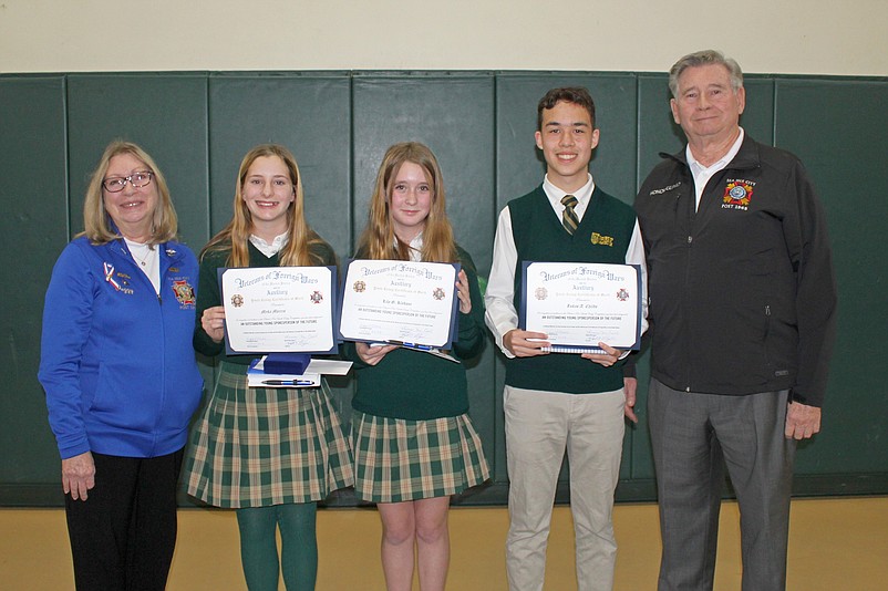 VFW Post 1963 Auxiliary President Peggy Moore and Post 1963 Sr. Vice Commander Tim MacAleer are shown at Bishop McHugh Regional Catholic School with the winners of the Patriot’s Pen Essay Competition: From left, Myka Morris, second place, Lily Klebaur, first place, and Lukas Childs, third place. (Photo courtesy of Sea Isle City)