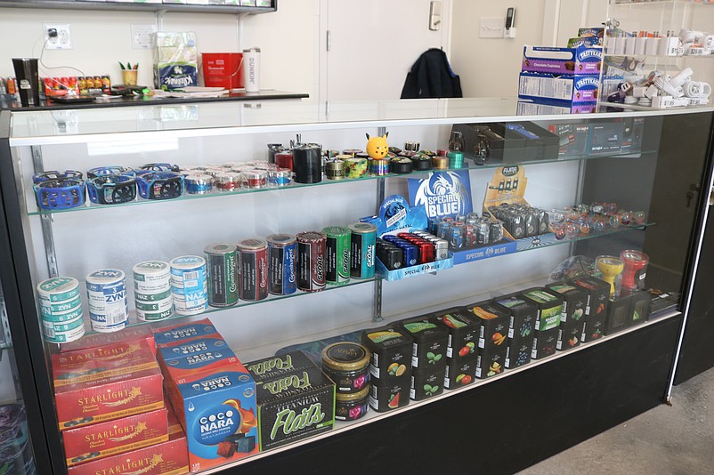 A display case at the smoke shop is stocked with specialty tobacco products.